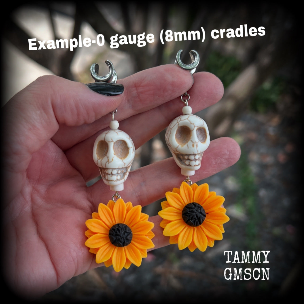 Featuring gorgeous orange sunflowers hanging beneath large bone white stone skulls, these earrings are big and beautiful !! 

These earrings weigh in at around 16 grams a piece, and nice and dangly at just under 8.5cms from tip to tip.

This pair have been made with 0 gauge (8mm) surgical steel cradles, suitable for stretched lobes.