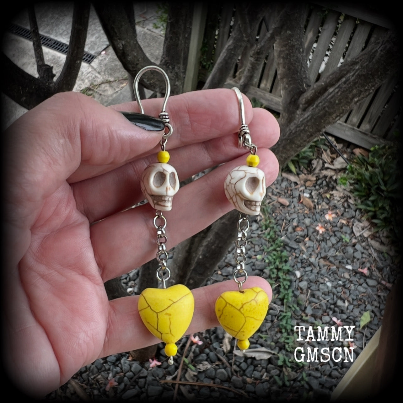 This pair of beautiful earrings features gorgeous canary yellow stone hearts dangling beneath bone white howlite stone skulls, measuring just on 9cms from tip to tip and weighing approx. 6 grams each, these are nice and dangly and not too heavy.

This pair have been made with small antique silver shephard hooks, suitable for stretched lobes when worn with silicone earlets from 8 gauge (3mm).