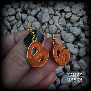 This pair of antique gold and enamel pretzel earrings measures just over 4cms from tip to tip, and are super light weight at only a few grams each.

This pair have been made with french hooks, suitable for both pierced ears.