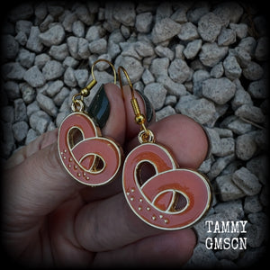 This pair of antique gold and enamel pretzel earrings measures just over 4cms from tip to tip, and are super light weight at only a few grams each.

This pair have been made with french hooks, suitable for both pierced ears.