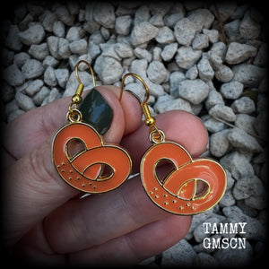 This pair of antique gold and enamel pretzel earrings measures just over 4cms from tip to tip, and are super light weight at only a few grams each.

This pair have been made with french hooks, suitable for both pierced ears.