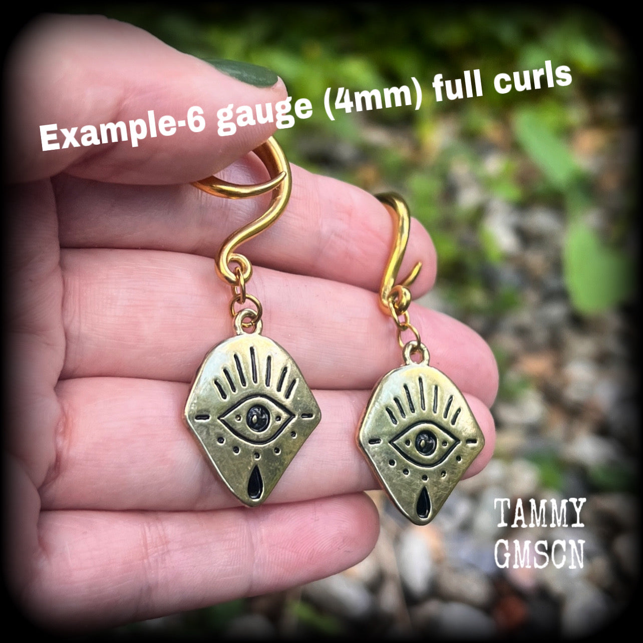 These awesome antique gold all seeing eye gauged earrings weigh approx 7 grams each, and are nice and dangly,hanging just over 6cms from tip to tip.
This pair have been made on 6 gauge (4mm) surgical steel full curl hooks,for stretched lobes.