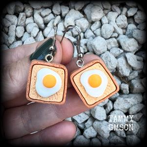 These pair of adorable earrings features eggs on bread!! Measuring just on 4cms from tip to tip, these earrings are nice and dangly and nice and light weight at only a few grams each.

This pair has been made with stainless steel french hooks for pierced ears.
