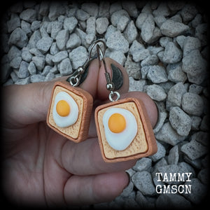 These pair of adorable earrings features eggs on bread!! Measuring just on 4cms from tip to tip, these earrings are nice and dangly and nice and light weight at only a few grams each.

This pair has been made with stainless steel french hooks for pierced ears.
