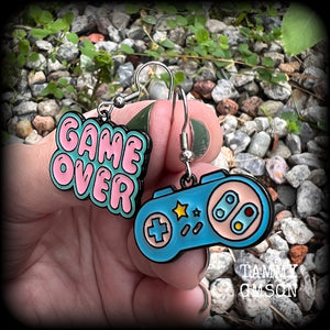 This pair of super cute ‘Game over’ gamer girl earrings measure approx 4cms from tip to tip, and weigh only a few grams each, lovely and lightweight and not too dangly.
This pair has been made with stainless steel french hooks, for pierced ears.