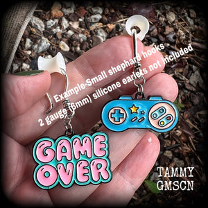 This pair of cute ‘Game over’ gamer girl earrings measure approx 4cms from tip to tip, and weigh only a few grams each, lovely and lightweight and not too dangly.
This pair has been made with antique silver small shephard hooks, for stretched lobes. 