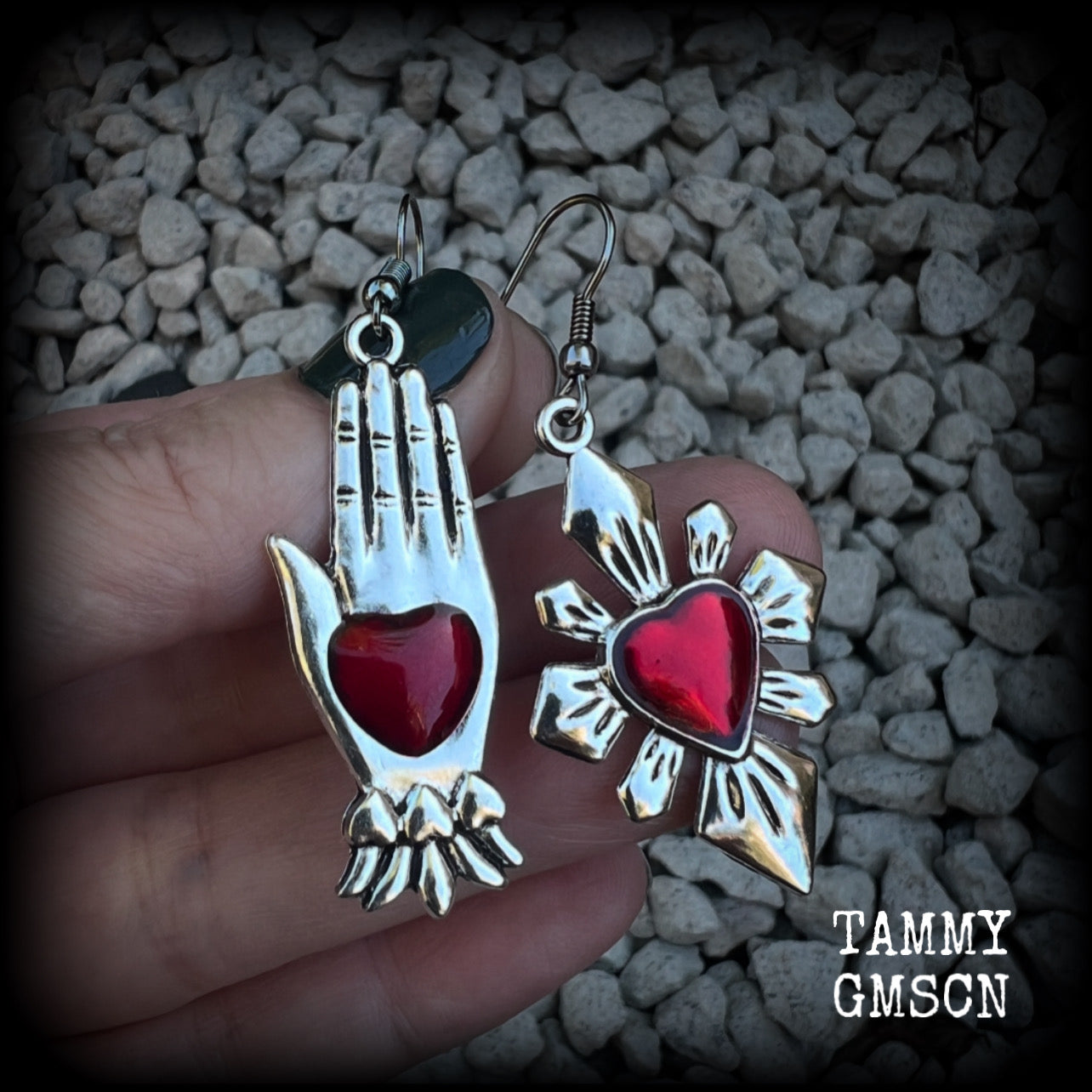 These beautiful red enamel and antique silver earrings feature a sacred heart with a sacred hand, are nice and lightweight at approx 5 grams a piece, measuring just on 6cms from tip to tip.

This pair has been made on stainless steel french hooks to be worn through pierced ears.
