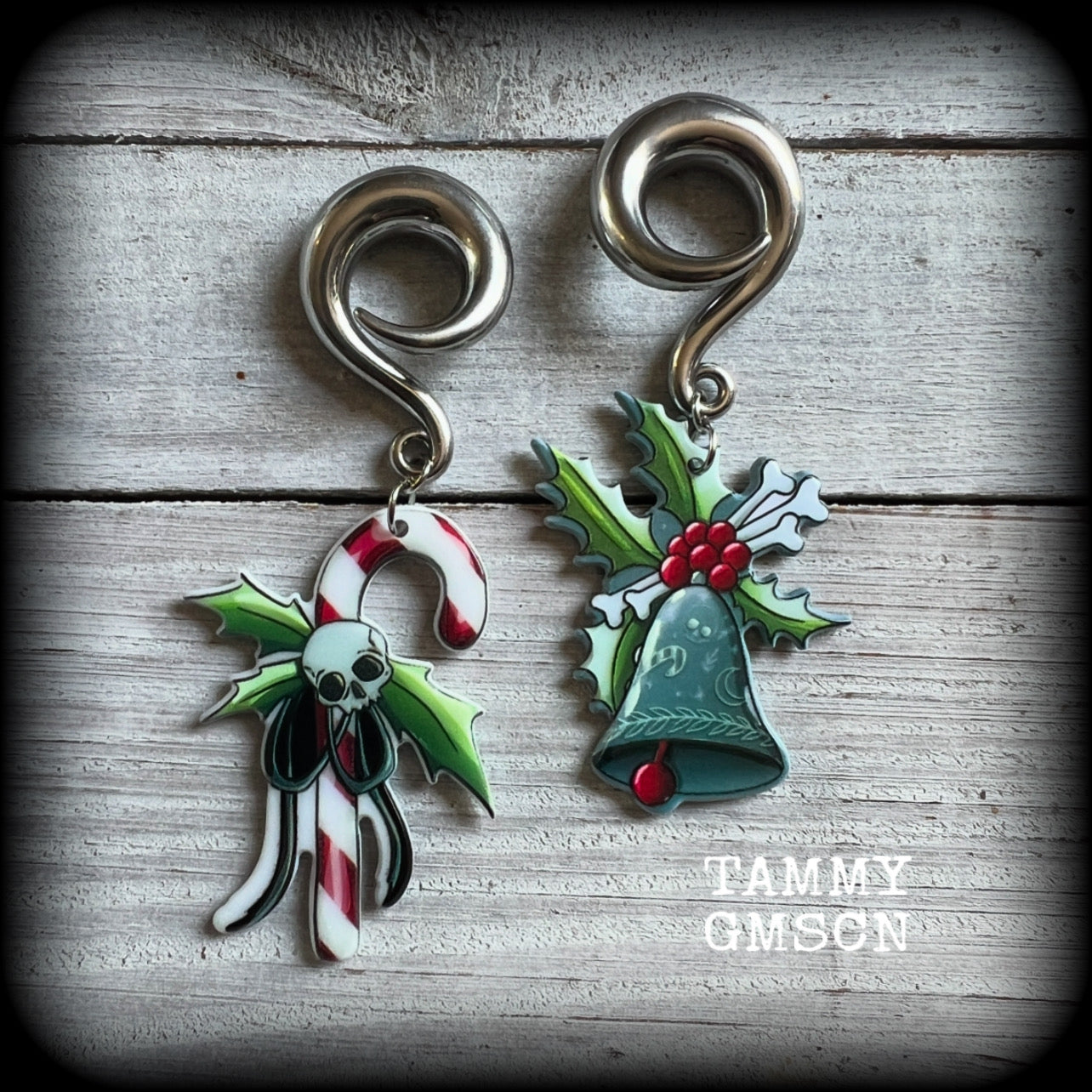 Featuring awesome acrylic candy cane skull and boney Christmas holly and bell charms, these earrings weigh approx 16 grams each, and are lovely and dangly at just under 9cms from tip to tip.

This pair has been made on 0 gauge (8mm) surgical steel full curl hooks, to be worn in stretched lobes.