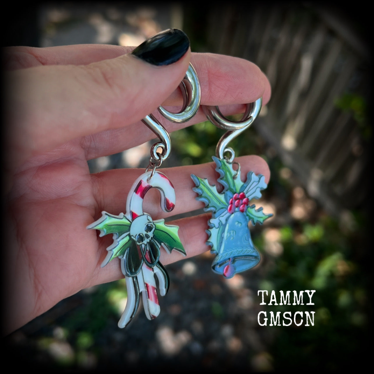 Featuring awesome acrylic candy cane skull and boney Christmas holly and bell charms, these earrings weigh approx 16 grams each, and are lovely and dangly at just under 9cms from tip to tip.

This pair has been made on 0 gauge (8mm) surgical steel full curl hooks, to be worn in stretched lobes.