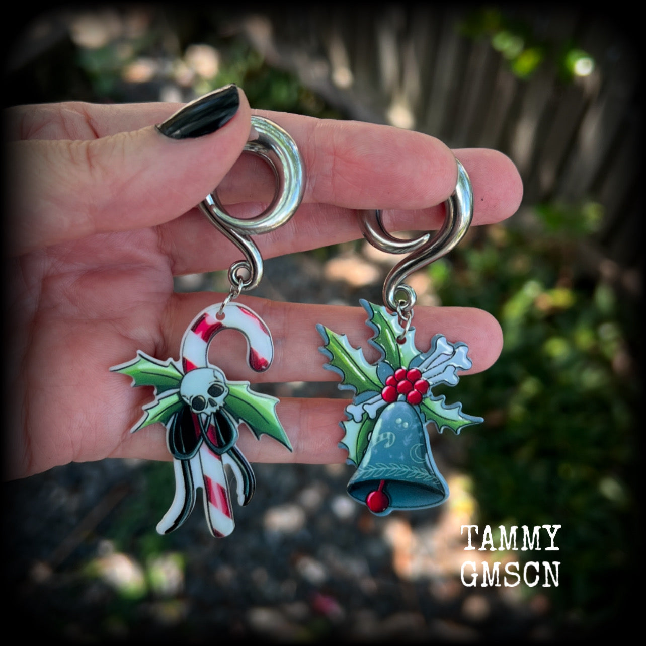 Featuring awesome acrylic candy cane skull and boney Christmas holly and bell charms, these earrings weigh approx 16 grams each, and are lovely and dangly at just under 9cms from tip to tip.

This pair has been made on 0 gauge (8mm) surgical steel full curl hooks, to be worn in stretched lobes.