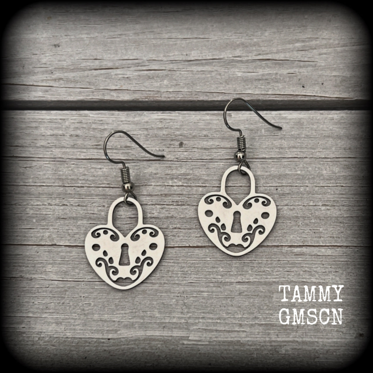 This pair of earrings feature a pretty in punk stainless steel heart padlock, measuring just on 4cms from tip to tip, weighing only a grams or two each.

This pair has been made on stainless steel french hooks, suitable for pierced ears.
