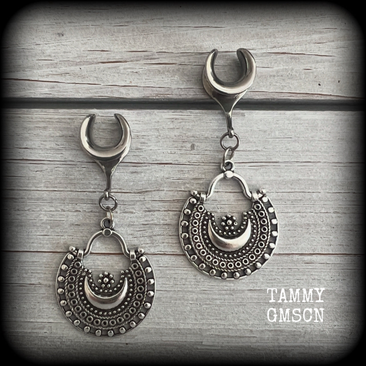 Inspired by Ishtar, Mesopotamian Goddess of love, beauty, sex and war, these beautiful ear hangers feature gorgeous boho antique silver crescent moons.

This is a lightweight pair of earrings at approx 5 grams each, and measuring just over 5.5cms from tip to tip.

This pair has been made on 00 gauge (10mm) surgical steel cradles, to be worn in stretched lobes.