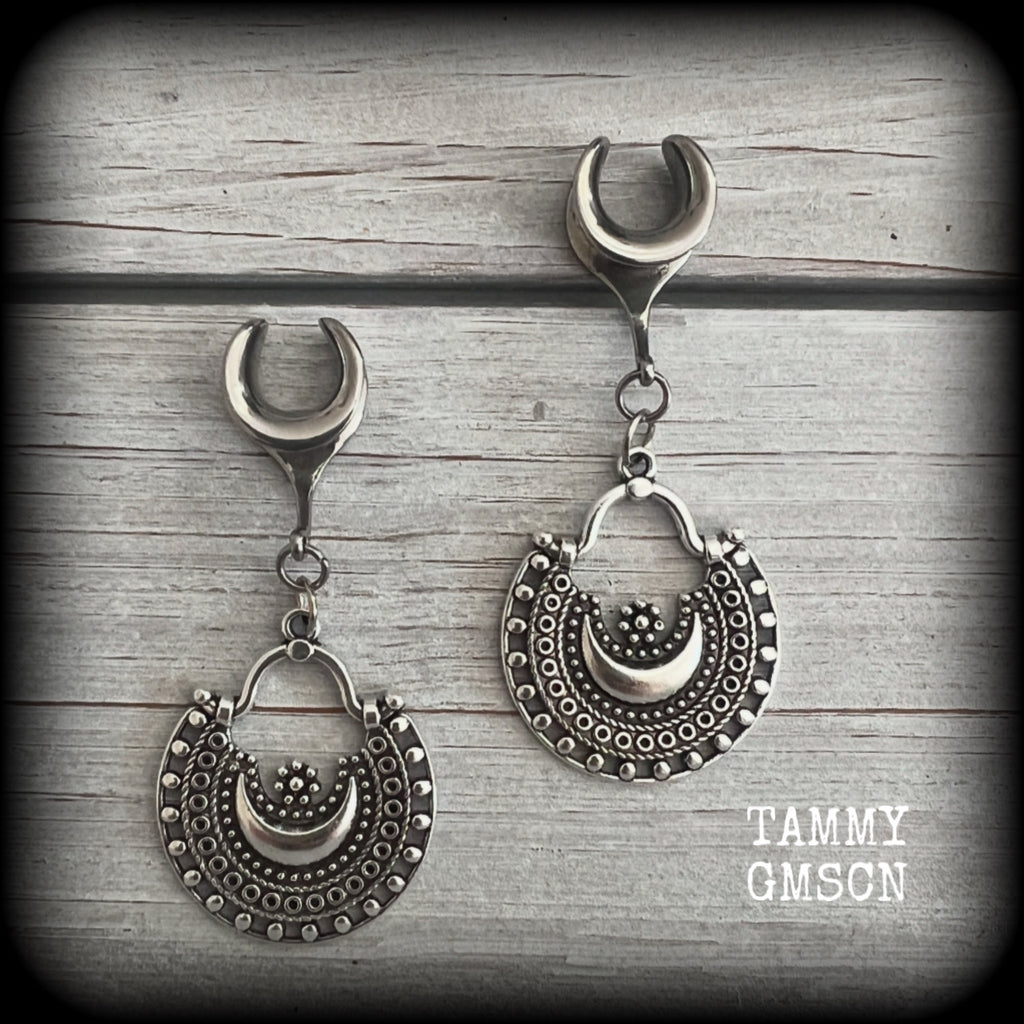 Inspired by Ishtar, Mesopotamian Goddess of love, beauty, sex and war, these beautiful ear hangers feature gorgeous boho antique silver crescent moons.

This is a lightweight pair of earrings at approx 5 grams each, and measuring just over 5.5cms from tip to tip.

This pair has been made on 00 gauge (10mm) surgical steel cradles, to be worn in stretched lobes.