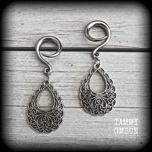 These beautiful ornate ear hangers feature antique silver filigree teardrop mandalas, inspired by Aphrodite, the Greek Goddess of love and beauty.
These earrings nice and light weight, weighing approx 6 grams a piece and measure just on 6.5cms from tip to tip.

This pair has been made on 6 gauge (4mm) surgical steel full curl hooks, suitable for stretched lobes.
