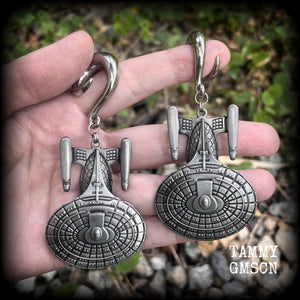 These gorgeous gauged earrings feature the Star Trek USS Enterprise, measuring just on 10cms from tip to tip and weighing approx 45 grams a piece, these earrings are BIG, DANGLY and HEAVY.

This pair has been made on 0 gauge (8mm) surgical steel full curl hooks, to be worn in stretched lobes.