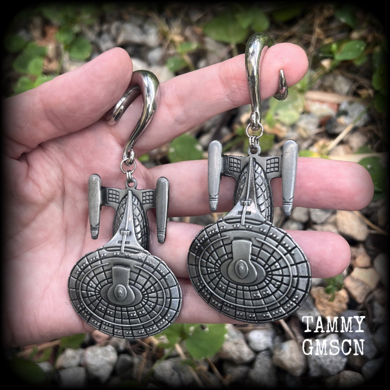 These gorgeous gauged earrings feature the Star Trek USS Enterprise, measuring just on 10cms from tip to tip and weighing approx 45 grams a piece, these earrings are BIG, DANGLY and HEAVY.

This pair has been made on 0 gauge (8mm) surgical steel full curl hooks, to be worn in stretched lobes.