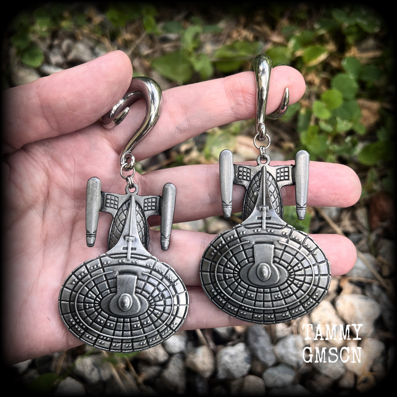 These gorgeous gauged earrings feature the Star Trek USS Enterprise, measuring just on 10cms from tip to tip and weighing approx 45 grams a piece, these earrings are BIG, DANGLY and HEAVY.

This pair has been made on 0 gauge (8mm) surgical steel full curl hooks, to be worn in stretched lobes.