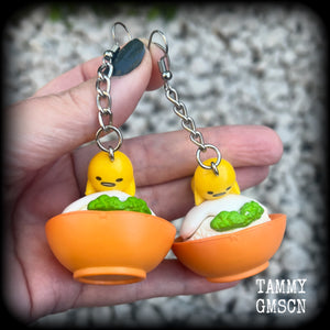 These earrings are TOO CUTE!!! Featuring the adorable Gudetama lazy egg man himself laying on a bowl of rice with a dash of wasabi, these earrings measure just on 8cms and weighing approx 20 grams.

This pair has been made on stainless steel french hooks, suitable for pierced ears.