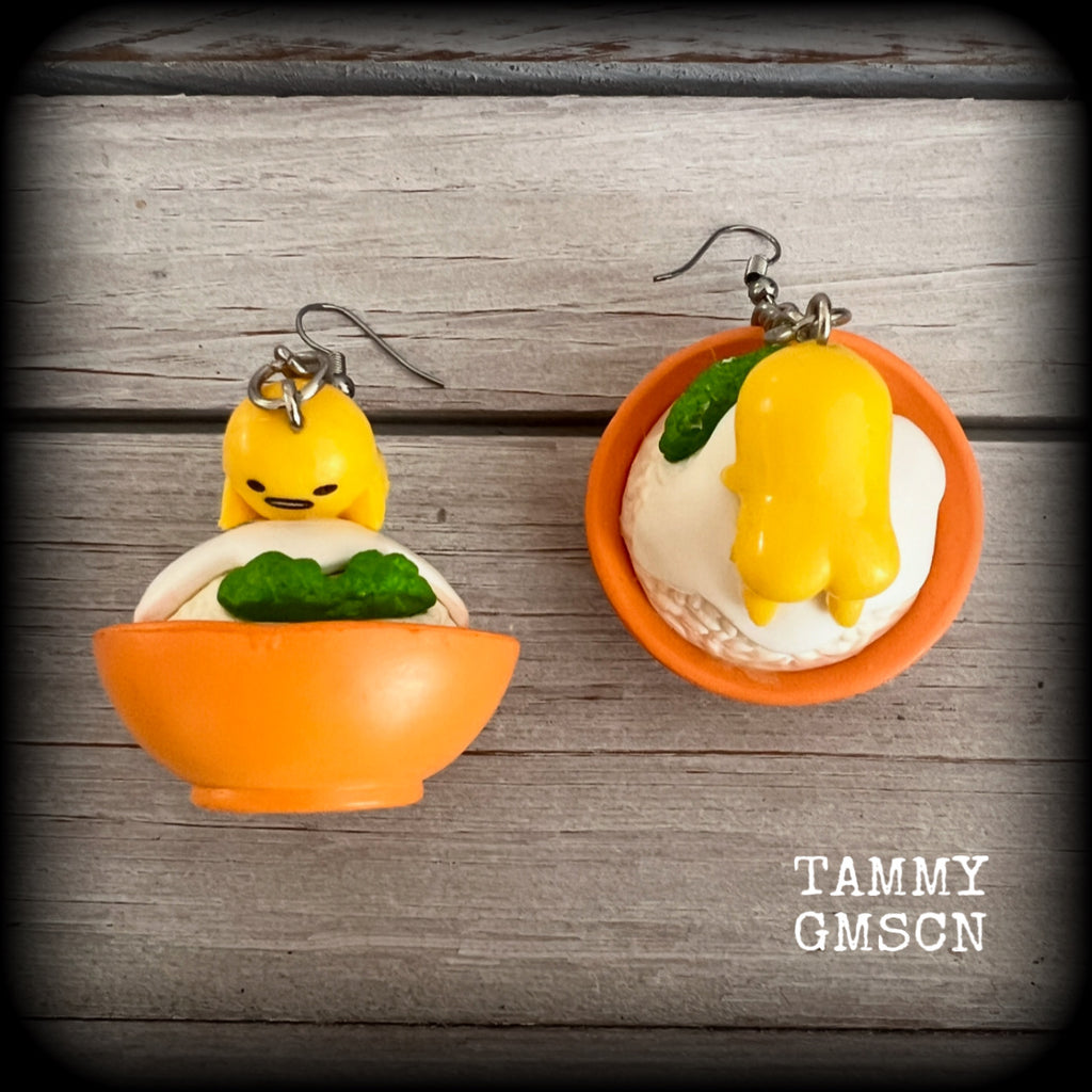These earrings are TOO CUTE!!! Featuring the adorable Gudetama lazy egg man himself laying on a bowl of rice with a dash of wasabi, these earrings measure just on 8cms and weighing approx 20 grams.

This pair has been made on stainless steel french hooks, suitable for pierced ears.
