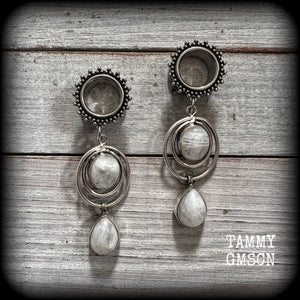 These earrings have been made with beautiful dangly polished rainbow moonstone gemstones, are light weight weighing approx 11 grams each and measuring just on 7cm from tip to tip.

This pair has been made with 9/16” gauge (14mm) gauge ornate surgical steel screw fit tunnels, for stretched lobes.