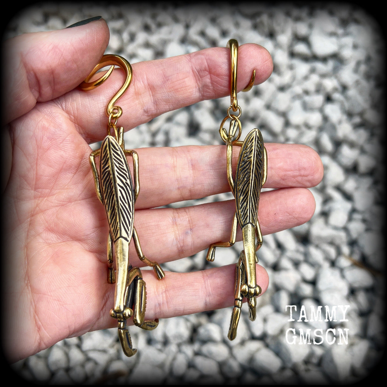 These awesome brass ear hangers feature gorgeous brass praying mantis pendants, measuring just on 10cms from tip to tip, and weighing approx 19 grams each, nice and dangly and not too heavy.

This pair has been made on 6 gauge (4mm) titanium coated surgical steel full curls, suitable for stretched lobes.