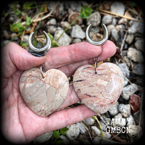 This is a pair of one-of-a-kind beautiful big Picture jasper heart gauged earrings, measuring just under 8cms from tip to tip, and weighing approx 25 grams each.
These earrings have been made on 3/4” gauge (19mm) surgical steel cradles.