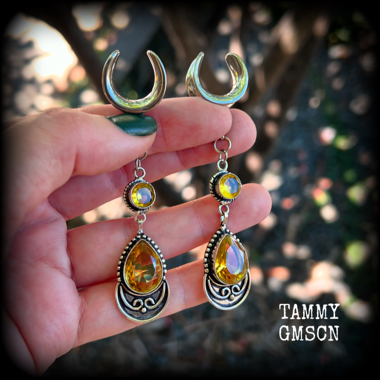 Featuring gorgeous golden yellow cutrine gemstone in a beautiful boho antique silver setting, these earrings measure just over 8cms from tip to tip, and weigh approx 11 grams each.

This pair have been made on 5/8” gauge (16mm) surgical steel full curl hooks, suitable for stretched lobes.
