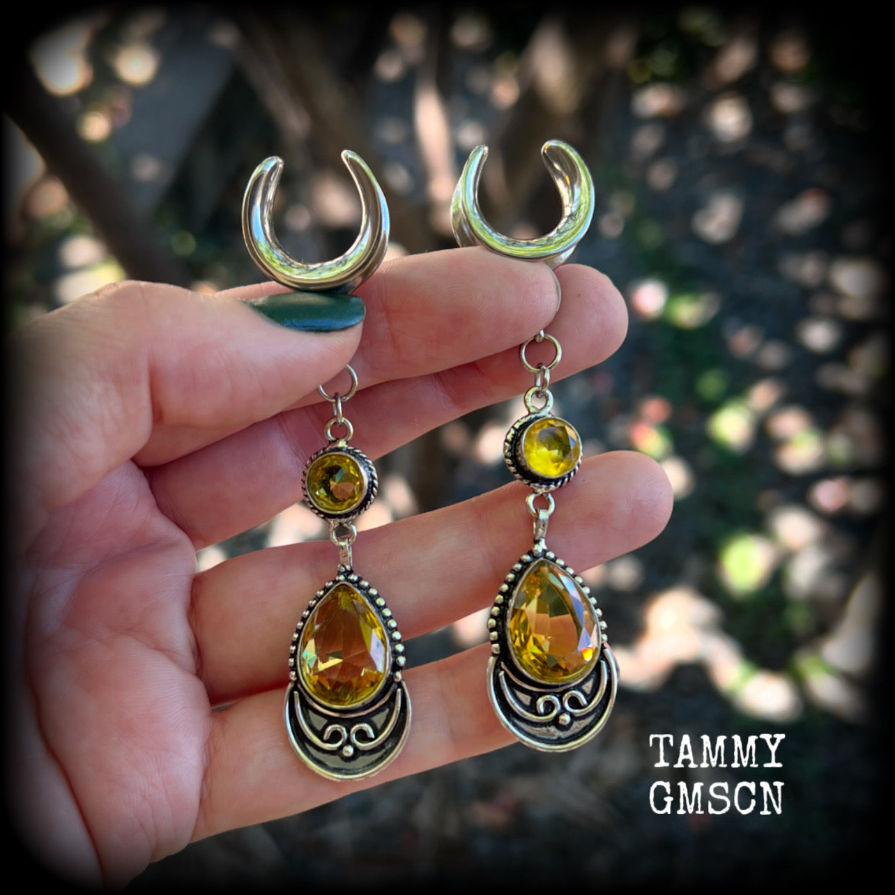 Featuring gorgeous golden yellow cutrine gemstone in a beautiful boho antique silver setting, these earrings measure just over 8cms from tip to tip, and weigh approx 11 grams each.

This pair have been made on 5/8” gauge (16mm) surgical steel full curl hooks, suitable for stretched lobes.

