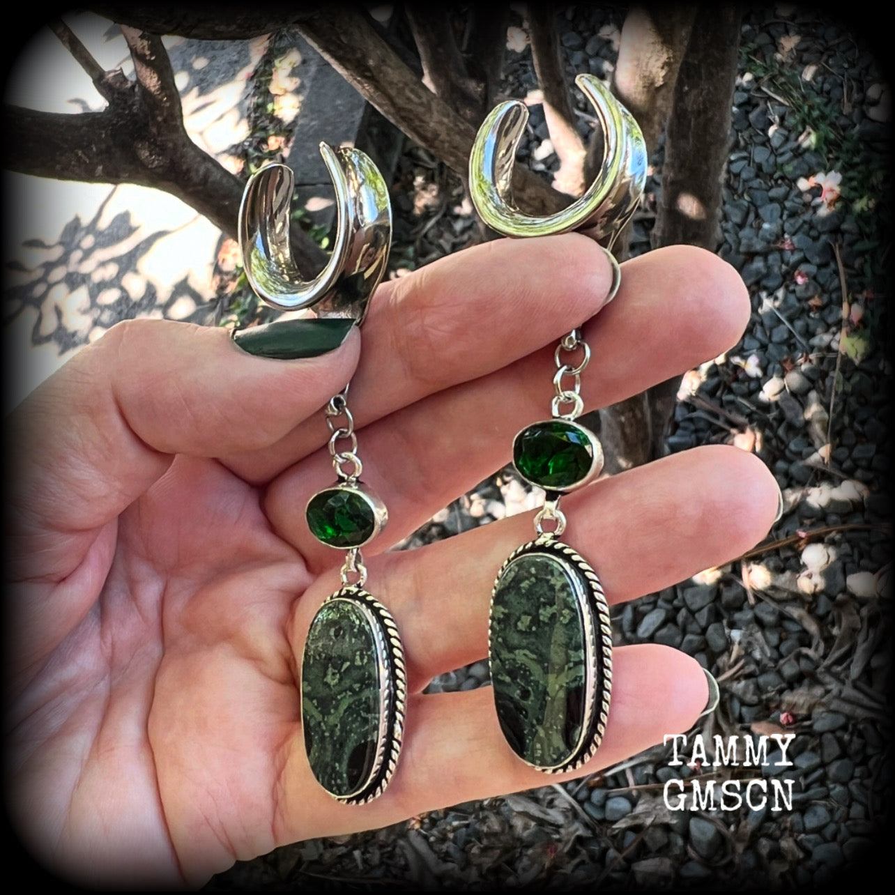 🖤 Kambaba jasper is a type of volcanic rock with orbs of fossilized algae that have been encased within it, known for providing a sense of calm, balance, and safety, and is often used in meditation 🖤

Featuring gorgeous green and black polished jasper stones hanging from deep green quartz crystals, these earrings measure just under 9cms from tip to tip, and weigh approx 12 grams each.

This pair have been made on 3/4” gauge (19mm) surgical steel cradles, suitable for stretched lobes.
