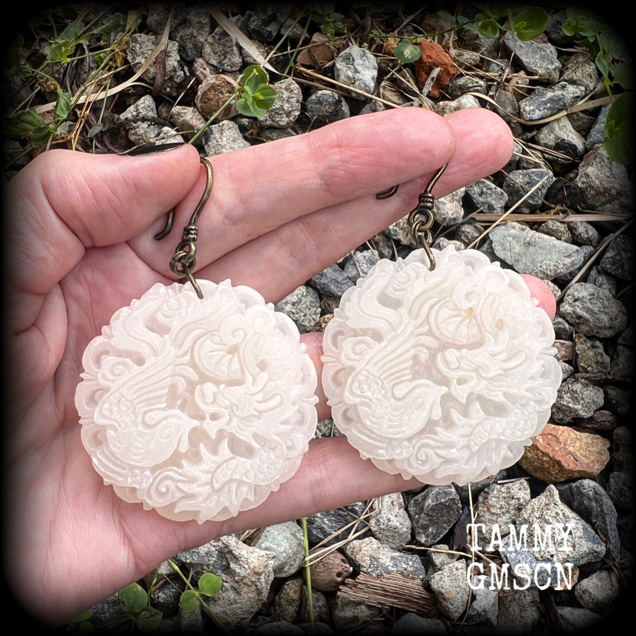 These jade earrings feature a dragon and phoenix, measuring 8 cms from tip to tip, and weighing 35 grams each.
This pair have been made on small antique bronze shephard hooks, to be worn with silicone earlets in stretched ears from 8 gauge (3mm).
