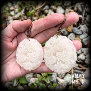These jade earrings feature a dragon and phoenix, measuring 8 cms from tip to tip, and weighing 35 grams each.
This pair have been made on small antique bronze shephard hooks, to be worn with silicone earlets in stretched ears from 8 gauge (3mm).