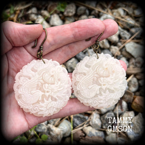 These jade earrings feature a dragon and phoenix, measuring 8 cms from tip to tip, and weighing 35 grams each.
This pair have been made on small antique bronze shephard hooks, to be worn with silicone earlets in stretched ears from 8 gauge (3mm).