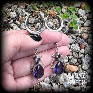 These earrings feature amethyst gemstones in an antique silver boho setting, measuring just over 7cms from tip to tip, and weighing approx 9 grams each, not too heavy...
Made on 3/4” gauge (19mm) surgical steel cradles-suitable for stretched lobes.