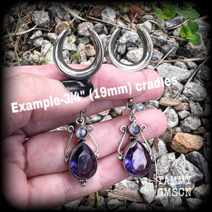 These earrings feature amethyst gemstones in an antique silver boho setting, measuring just over 7cms from tip to tip, and weighing approx 9 grams each, not too heavy...
Made on 3/4” gauge (19mm) surgical steel cradles-suitable for stretched lobes.