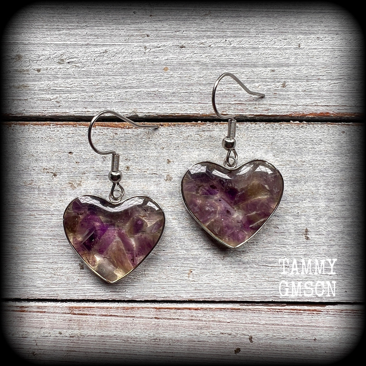 These beautiful gemstone earrings feature gorgeous amethyst gemstone chips set in a resin heart, are nice and lightweight at only 3 grams each and measure just on 4cms from tip to tip.

This pair have been made with stainless steel french hooks, for pierced ears.