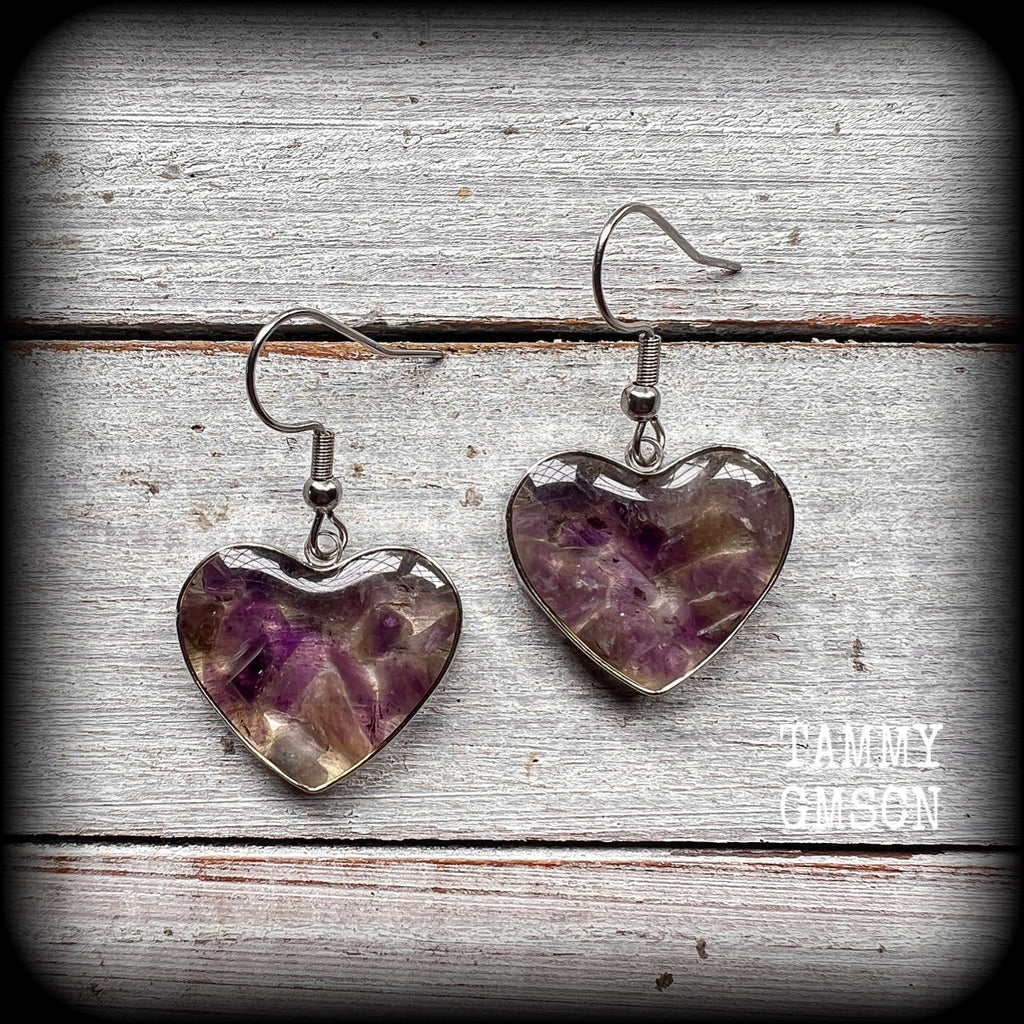 These beautiful gemstone earrings feature gorgeous amethyst gemstone chips set in a resin heart, are nice and lightweight at only 3 grams each and measure just on 4cms from tip to tip.

This pair have been made with stainless steel french hooks, for pierced ears.