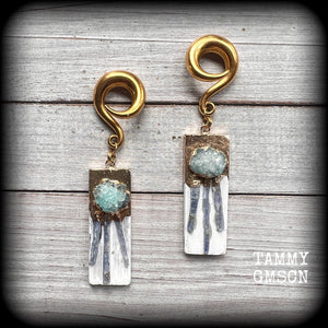 These unique gauged earrings feature selenite with ocean green druzy and sky blue kyanite, measuring approx 10cms from tip to tip, and weighing approx 25 grams each.

This pair have been made on 0 gauge (8mm) surgical steel full curl hooks, to be worn in stretched lobes.