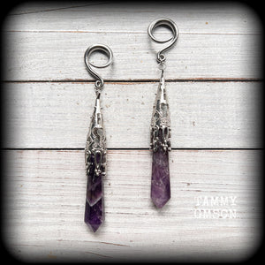 These gorgeous gothic gauged earrings feature a pair of beautiful long purple amethysts set in an antique silver setting, weighing approx 19 grams a piece and measuring approx 11cms from tip to tip.

This pair has been made on 6 gauge (4mm) surgical steel full curl hooks, to be worn in stretched lobes.