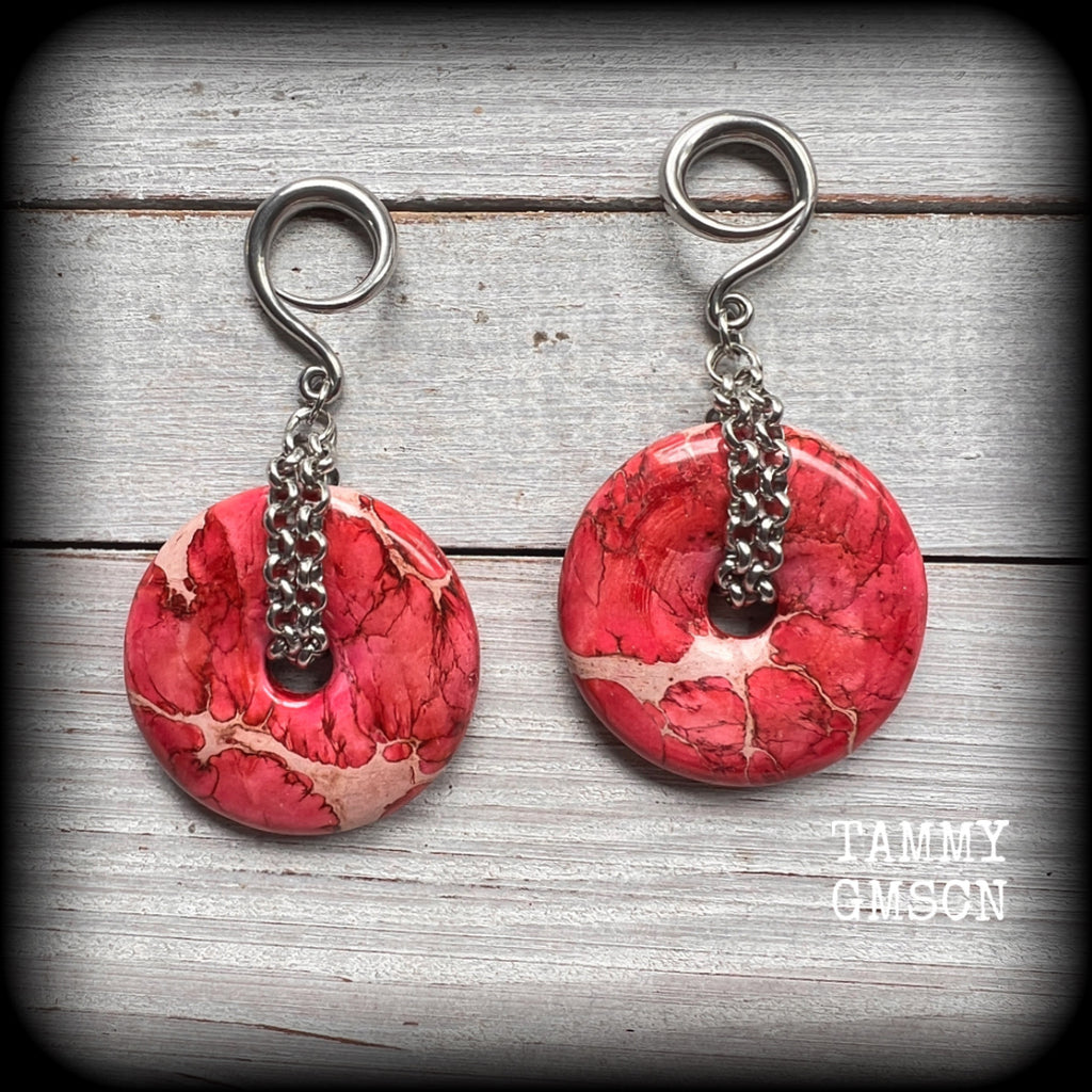 This pair of gorgeous ocean jasper earrings features beautiful pink marbled donut gemstones, weighing approx 19 grams a piece, and measuring 8cms from tip to tip.

This pair has been made on 6 gauge (4mm) surgical steel full curl hooks, to be worn in stretched lobes.