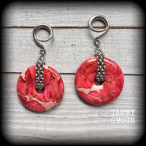 This pair of gorgeous ocean jasper earrings features beautiful pink marbled donut gemstones, weighing approx 19 grams a piece, and measuring 8cms from tip to tip.

This pair has been made on 6 gauge (4mm) surgical steel full curl hooks, to be worn in stretched lobes.