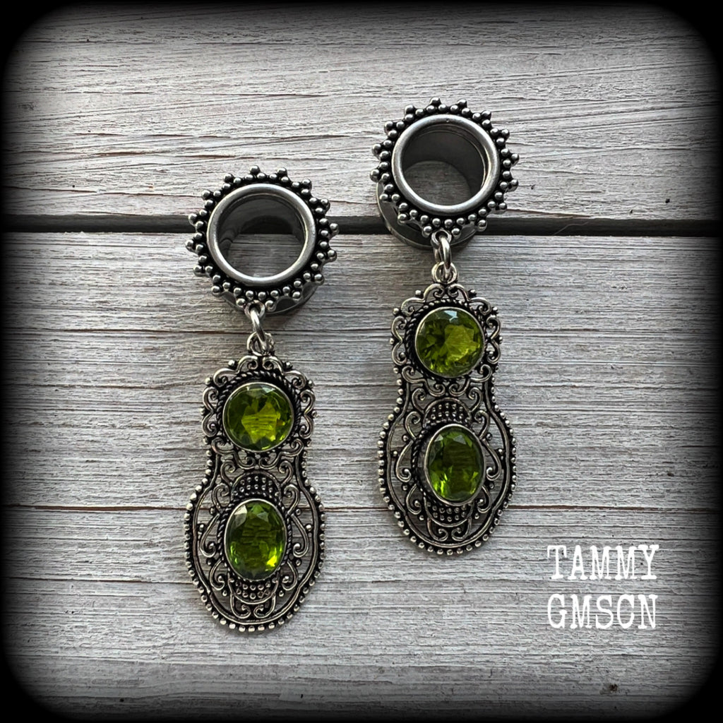 These beautiful boho tunnel earrings feature gorgeous green peridot gemstones in a gypsy boho style antique silver setting, weighing approx 9 grams each and measuring just under 6cms from tip to tip.

This pair have been made with 1/2” (12mm) gauge ornate surgical steel screw fit tunnels.