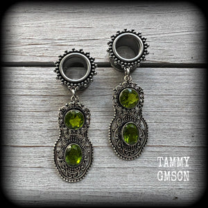 These beautiful boho tunnel earrings feature gorgeous green peridot gemstones in a gypsy boho style antique silver setting, weighing approx 9 grams each and measuring just under 6cms from tip to tip.

This pair have been made with 1/2” (12mm) gauge ornate surgical steel screw fit tunnels.