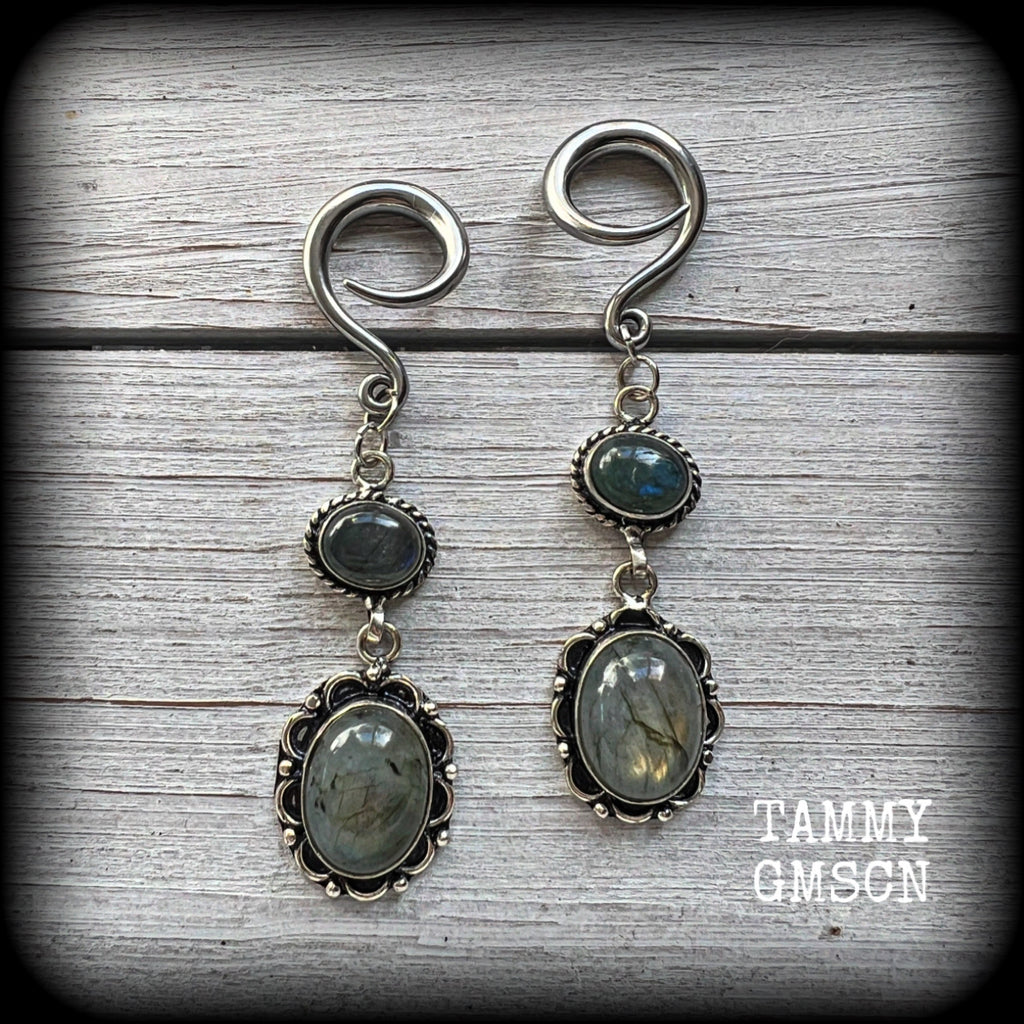 These gorgeous gemstone earrings feature beautiful polished labradorite gemstones in a gorgeous boho antique silver setting. Lovely and dangly, these earrings measure 7.5cms from tip to tip, and weigh approx 10 grams each.

This pair have been made with 6 gauge (4mm) surgical steel full curl hooks, suitable for stretched lobes.