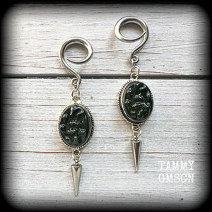 This pair of earrings features gorgeous forest green moldavite gemstones in a boho antique silver setting, weighing approx 10 grams a piece and measuring just on 8cms from tip to tip.

This pair have been made on 6 gauge (4mm) surgical steel full curl hooks, to be worn in stretched lobes.