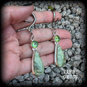 These beautiful Serpentine and green garnet earrings are made with gorgeous polished and faceted gemstones, lovely and dangly measuring just approx 7.5cms from tip to tip, and weighing approx 9 grams each.   These earrings have been made on 6 gauge (4mm) surgical steel full curl hooks, to be worn in stretched lobes.