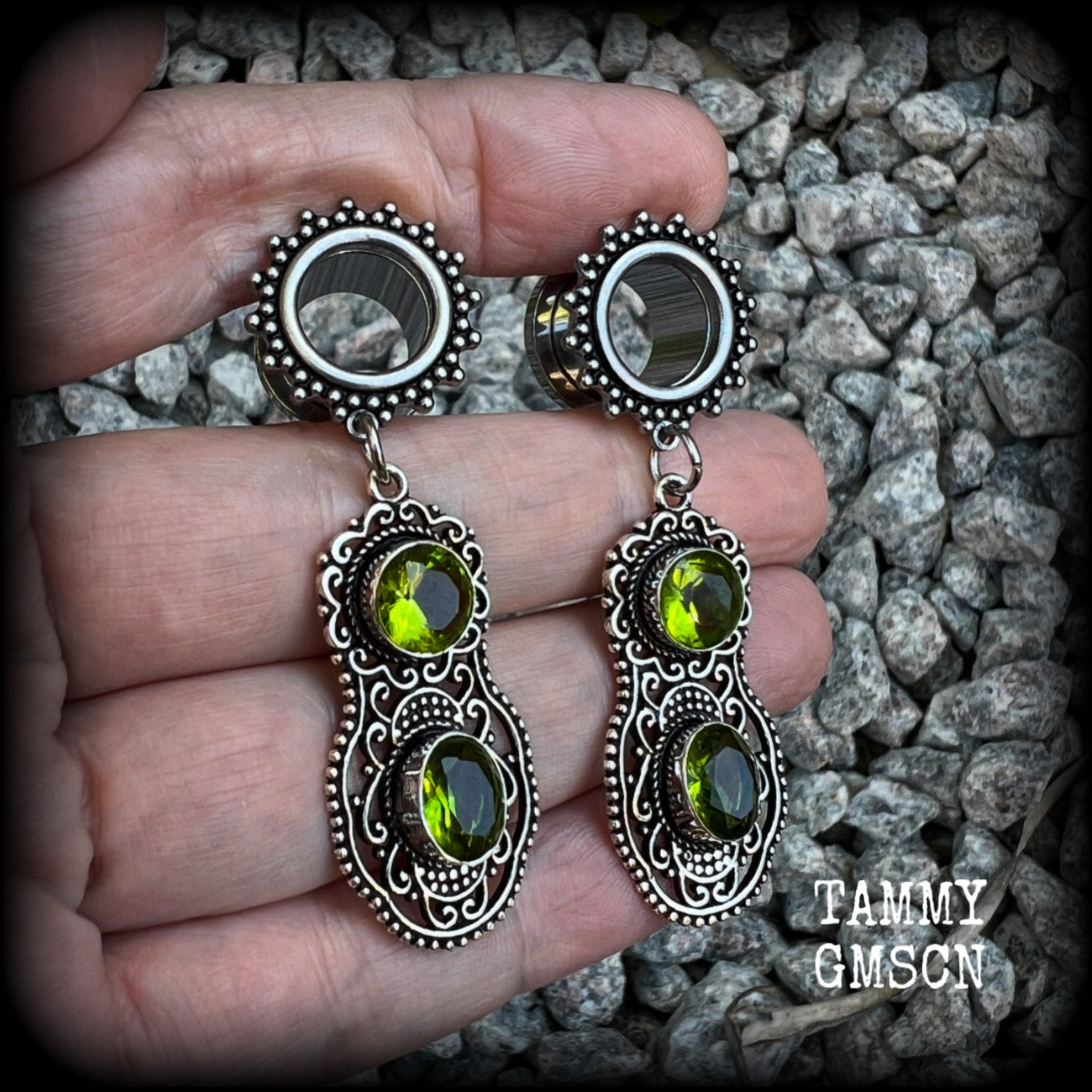 These beautiful boho tunnel earrings feature gorgeous green peridot gemstones in a gypsy boho style antique silver setting, weighing approx 9 grams each and measuring just under 6cms from tip to tip.  This pair have been made with 1/2” (12mm) gauge ornate surgical steel screw fit tunnels.