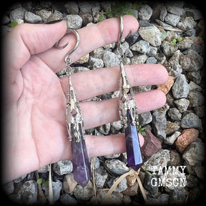 These gorgeous gothic gauged earrings feature a pair of beautiful long purple amethysts set in an antique silver setting, weighing approx 19 grams a piece and measuring approx 11cms from tip to tip.

This pair has been made on 6 gauge (4mm) surgical steel full curl hooks, to be worn in stretched lobes.