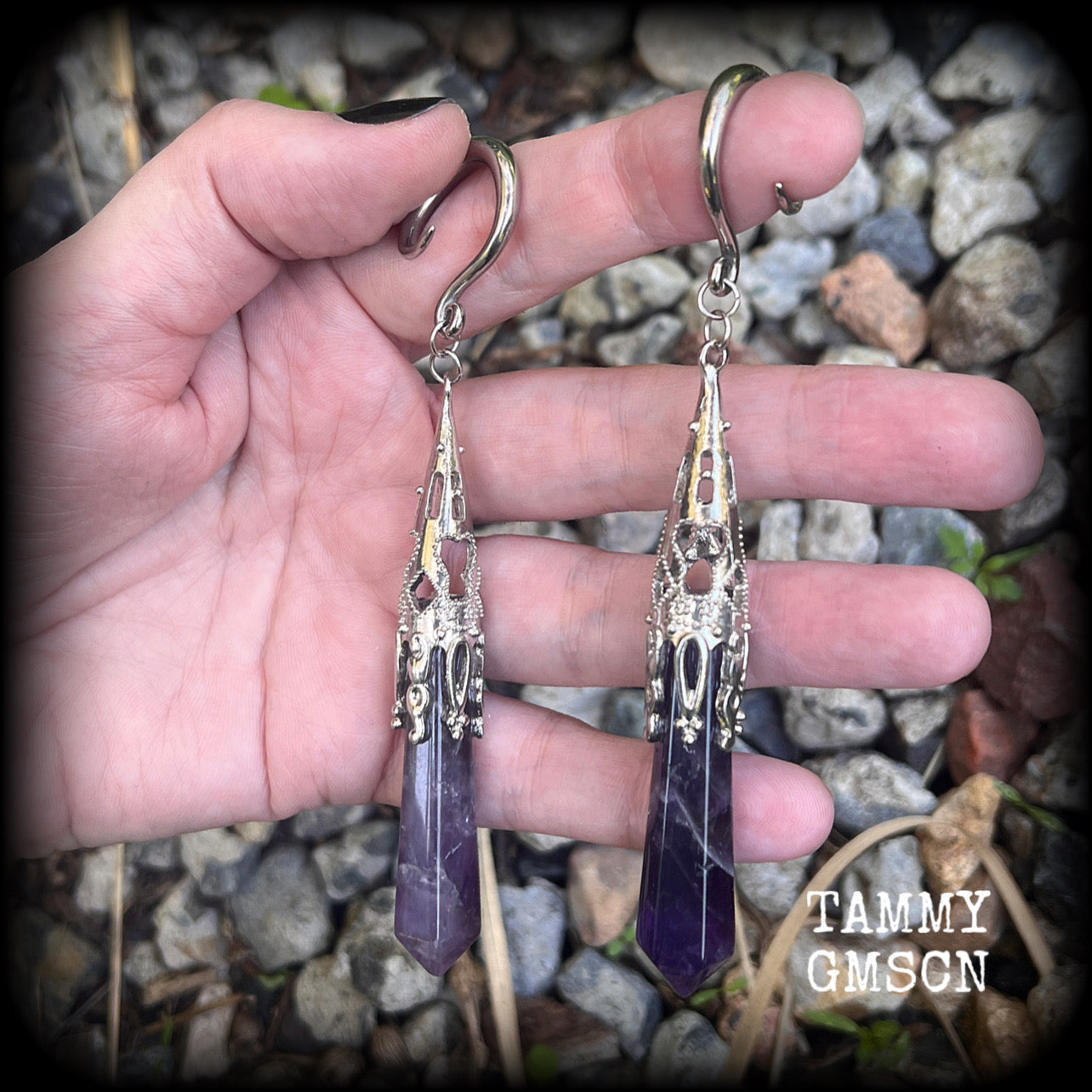 These gorgeous gothic gauged earrings feature a pair of beautiful long purple amethysts set in an antique silver setting, weighing approx 19 grams a piece and measuring approx 11cms from tip to tip.

This pair has been made on 6 gauge (4mm) surgical steel full curl hooks, to be worn in stretched lobes.