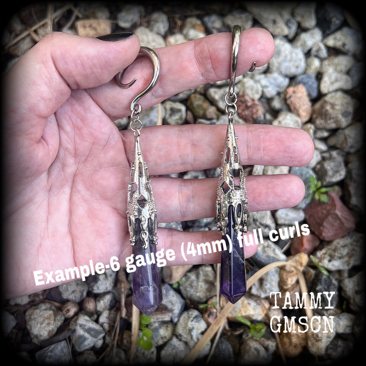 These gorgeous gothic gauged earrings feature a pair of beautiful long purple amethysts set in an antique silver setting, weighing approx 19 grams a piece and measuring approx 11cms from tip to tip.

This pair has been made on 6 gauge (4mm) surgical steel full curl hooks, to be worn in stretched lobes.