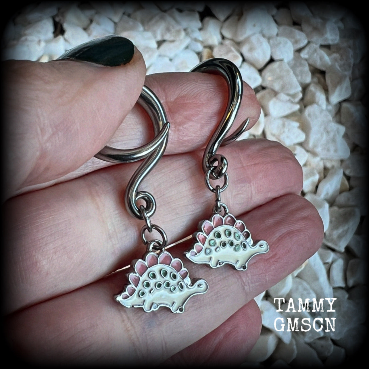 These adorable pink and white enamel stegosaurus gauged earrings are nice and light weight at approx 5 grams a piece, and nice and dangly at just under 5cms from tip to tip.

This pair has been made on 6 gauge (4mm) surgical steel full curl hooks, to be worn in stretched lobes.